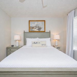 Serene guest bedroom featuring a queen bed, soft linens, and coastal decor that enhances your relaxation