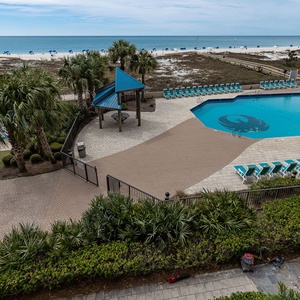 Enjoy views of the inviting pool and the shore beyond from your balcony