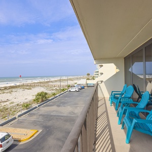 Breathtaking beachfront views from the balcony, featuring comfortable seating for relaxation and ocean breezes