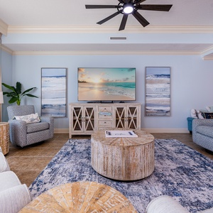 Unwind on the plush seating in this living space, featuring a sofa with a queen sleeper and coastal decor