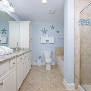 Tiled shower and granite counters in the master bath invite you to refresh after a day on the coast