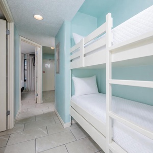 Cozy bunk beds provide a fun sleeping option for kids, with a bright and inviting space to unwind after a day of adventure