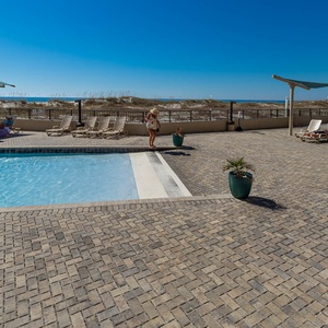 Inviting gradual entry pool with comfortable lounge chairs and a refreshing atmosphere, perfect for relaxation