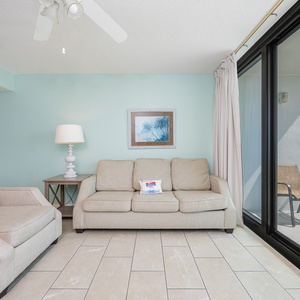 Light fills the living room from the balcony as you relax on the sofa with a queen sleeper