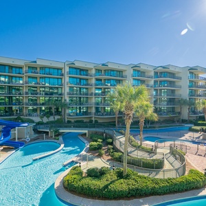 Savor the sunshine and laughter as you enjoy the vibrant pool area from your spacious balcony retreat