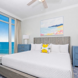 Relax on the cozy king bed in this guest suite and enjoy a beautiful sunrise from floor-to-ceiling windows