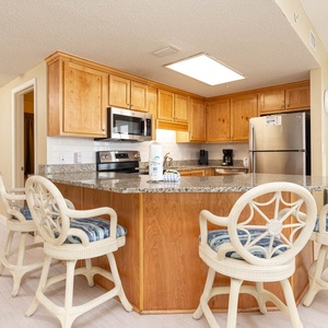 Gather around the stylish bar seating as you enjoy meals prepared in the well-designed kitchen with granite countertops