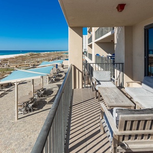 Enjoy the fresh air while relaxing on the comfortable seating of your balcony with views of the beach and pool area