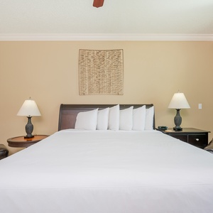 Sink into the plush king bedding as you enjoy a restful night in the serene atmosphere of this master bedroom