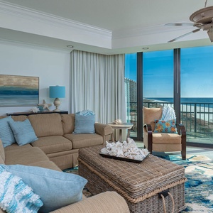 Unwind in the inviting living area, featuring a plush sectional with queen sleeper, coastal decor, and expansive windows
