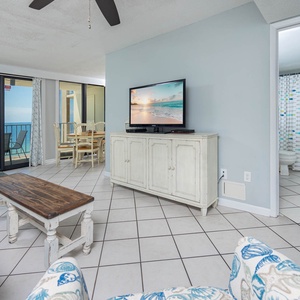 This inviting living area features a cozy seating arrangement, a TV for entertainment, queen sofa-sleeper, and a beach view