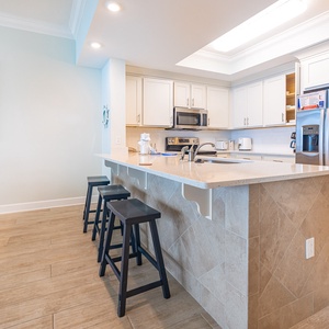 Sip your morning coffee at the breakfast bar and get ready for a beach day in this stylish space