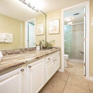 The master bath features a stylish marble countertop, a walk-in shower, and plush towels for a refreshing experience
