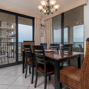 Dine with a view in this inviting space featuring a large table and sliding doors that open to the fresh gulf air