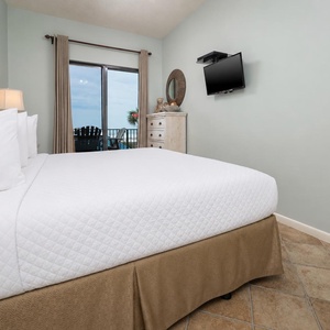 Enjoy restful nights in the master bedroom with a king bed, TV, and a stunning beach view