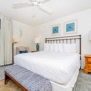 Enjoy restful nights in this master bedroom with a king bed, stylish decor, and easy access to the balcony beach views