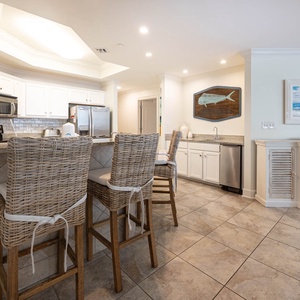 The kitchen features stainless appliances, granite countertops, and a stylish bar, perfect for casual dining and entertaining