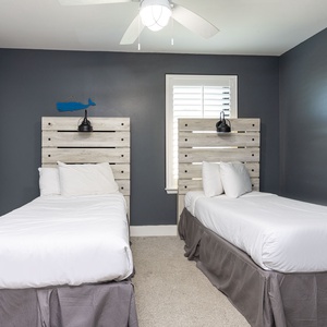 Cozy twin guest bedroom featuring stylish wood headboards and soft lighting for a restful night's sleep