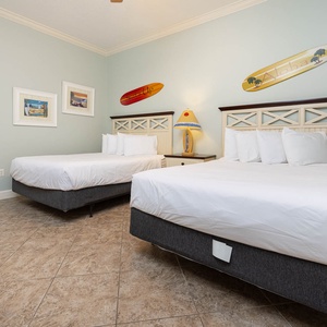 Rest in comfort on two plush queen beds in this guest room, enjoying tranquil decor while sharing stories and laughter