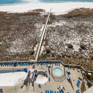 Overlooking the pool area, this view showcases the inviting kiddie pool and lounge chairs leading to the pristine beach