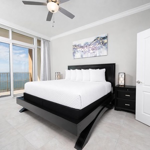 Relax in this elegant king master suite with cozy bedding and drift off to the sound of the waves from the balcony