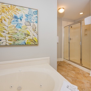 Refresh in the master bath after a day at the beach with a soothing jetted tub and relaxing walk-in shower