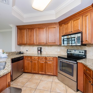 The kitchen features wooden cabinetry, stainless appliances, and a granite countertop, perfect for meal prep and entertaining