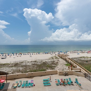 Enjoy the vibrant beach view with lounge chairs and umbrellas inviting you to relax by the water's edge