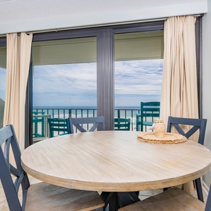 Enjoy meals at this inviting table with stunning beachfront views just beyond the sliding glass doors