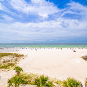 Gaze at the expansive shoreline and calm waters, perfect for a relaxing day in the sun