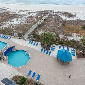 Take a refreshing dip in the inviting pool surrounded by lounge chairs and tropical landscaping for your relaxation