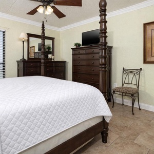 Cozy master suite with elegant wooden furnishings and a charming view through the window