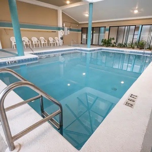 Dip into the indoor pool with comfortable seating nearby, perfect for unwinding after a day at the beach at Romar Place