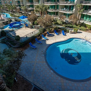 Discover the pool area with a refreshing lazy river and thrilling waterslide, just steps from the bay