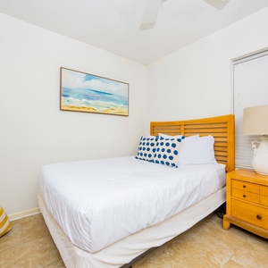 Enjoy a restful night in this inviting guest bedroom featuring a comfortable queen bed, playful decor, and soft lighting
