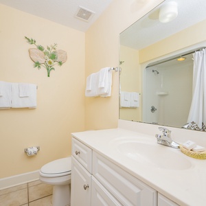 Enjoy a relaxing shower after a day of adventure in this guest bath with stylish accents and fluffy towels