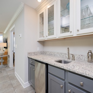 Grab a chilled drink from the fridge or create your favorite cocktail at the wet bar with elegant glassware displays