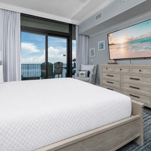 Relax in the master suite with a king bed, large TV, and beachfront balcony access