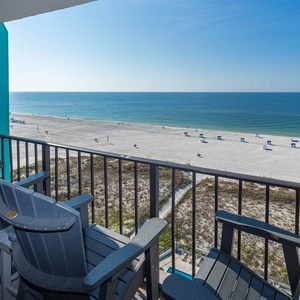 Enjoy breathtaking beachfront views from the cozy balcony, featuring comfortable seating for relaxation and tranquility