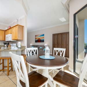 Gather around the round dining table, enjoying views through sliding glass doors that lead to the balcony