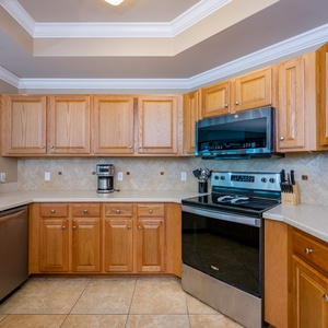 Craft delicious meals together in the charming kitchen, where family laughter blends with the vibrant coastal vibe