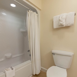 Rejuvenate with a delightful rinse in the guest bath with local festival decor for a refreshing start