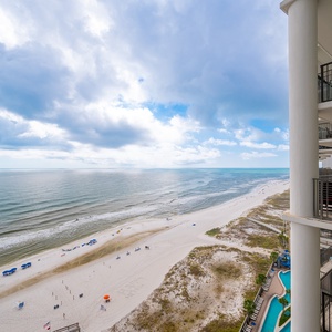 Impressive coastal views from a spacious balcony overlooking pristine shoreline and vibrant beach umbrellas