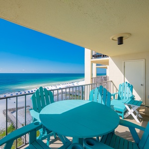 Relax on the patio furniture while enjoying breathtaking views of the serene beach and clear blue waters