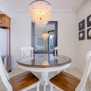 Gather around the table and enjoy meals beneath the glow of a stunning chandelier