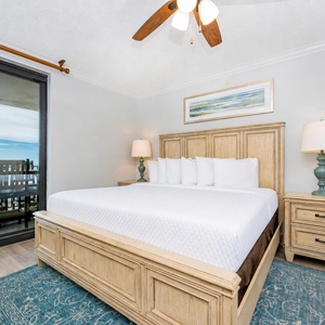 Retreat to this serene master bedroom featuring a king bed, stylish decor, and beachfront balcony access