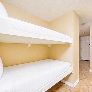 The nook features a bunk bed with fresh linens, perfect for kids or extra guests, enhancing your family vacation experience
