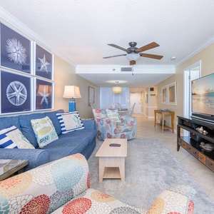 Relax on the plush sofa with a queen sleeper, enjoying your favorite show as coastal decor enhances the beach vibe
