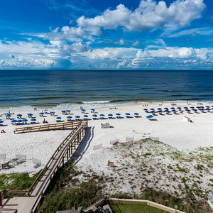 Relax with views of the beach and inviting blue umbrellas from your private balcony on the 6th floor