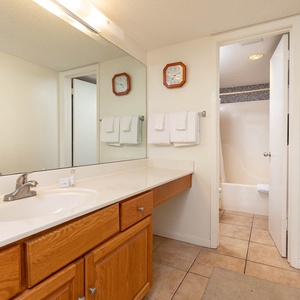 Spacious master bath with a large vanity, ample storage, and a relaxing tub shower for your comfort